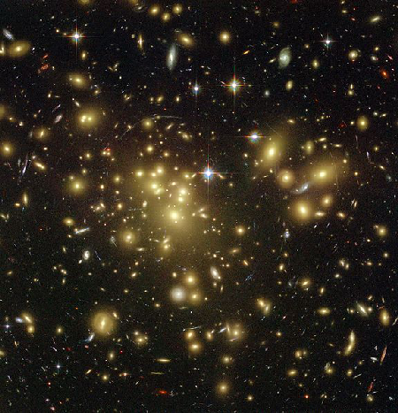 Galaxy cluster Abell 1689.  The curved arcs in this picture are caused by gravitational lensing.  The radius of the arc tells us how heavy the lensing object is.